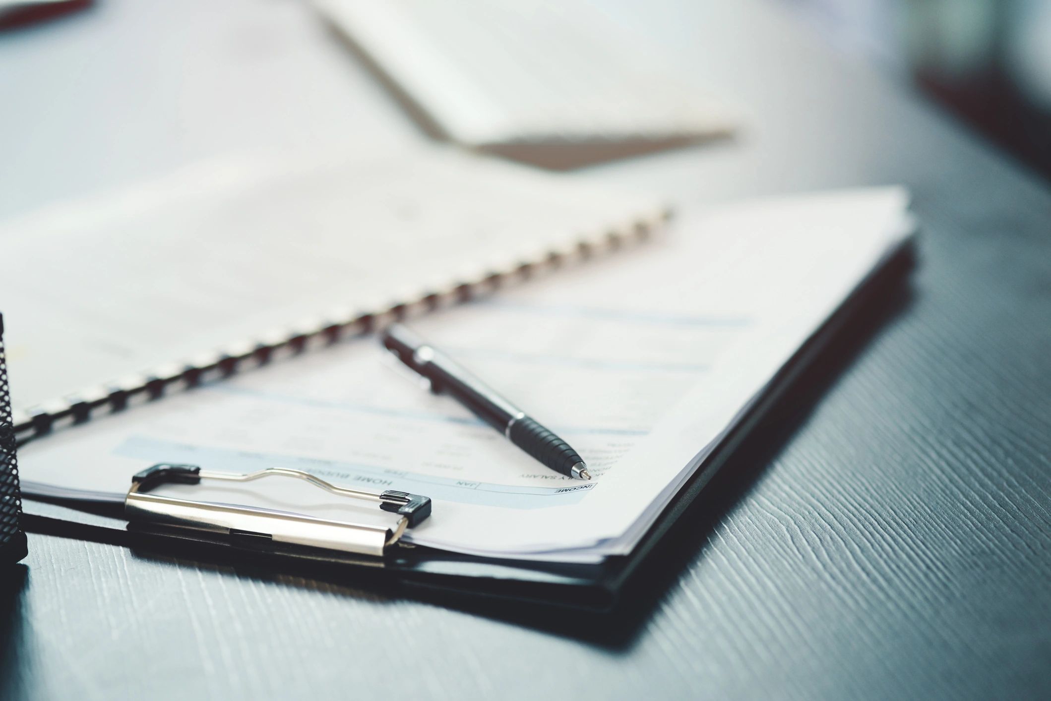 Notebook and pen on an office desk
